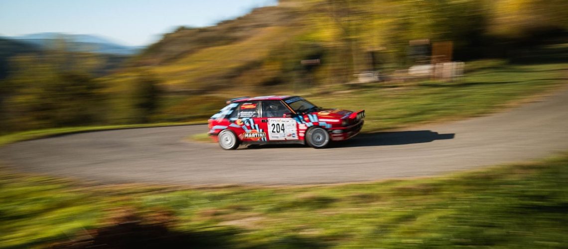 a small car driving down a winding road