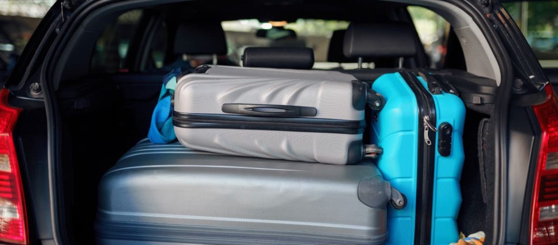 suitcases-in-opened-car-trunk-on-parking-nobody-2024-11-29-00-10-12-utc